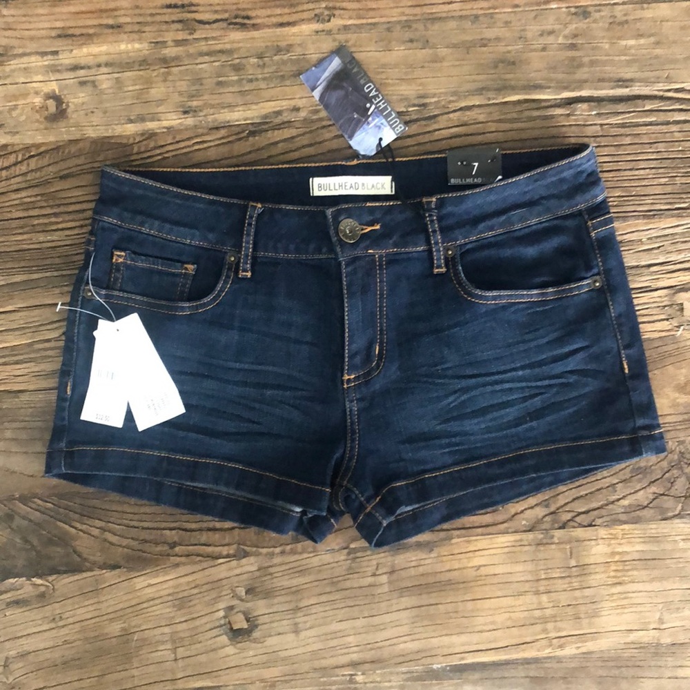 Dark wash denim shorts. Basic clean hem, low rise.